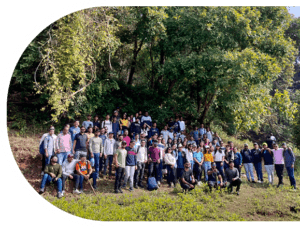 A diverse group of employees at one of the best IT company in Surat, smiling together at the picnic showcasing company culture.
